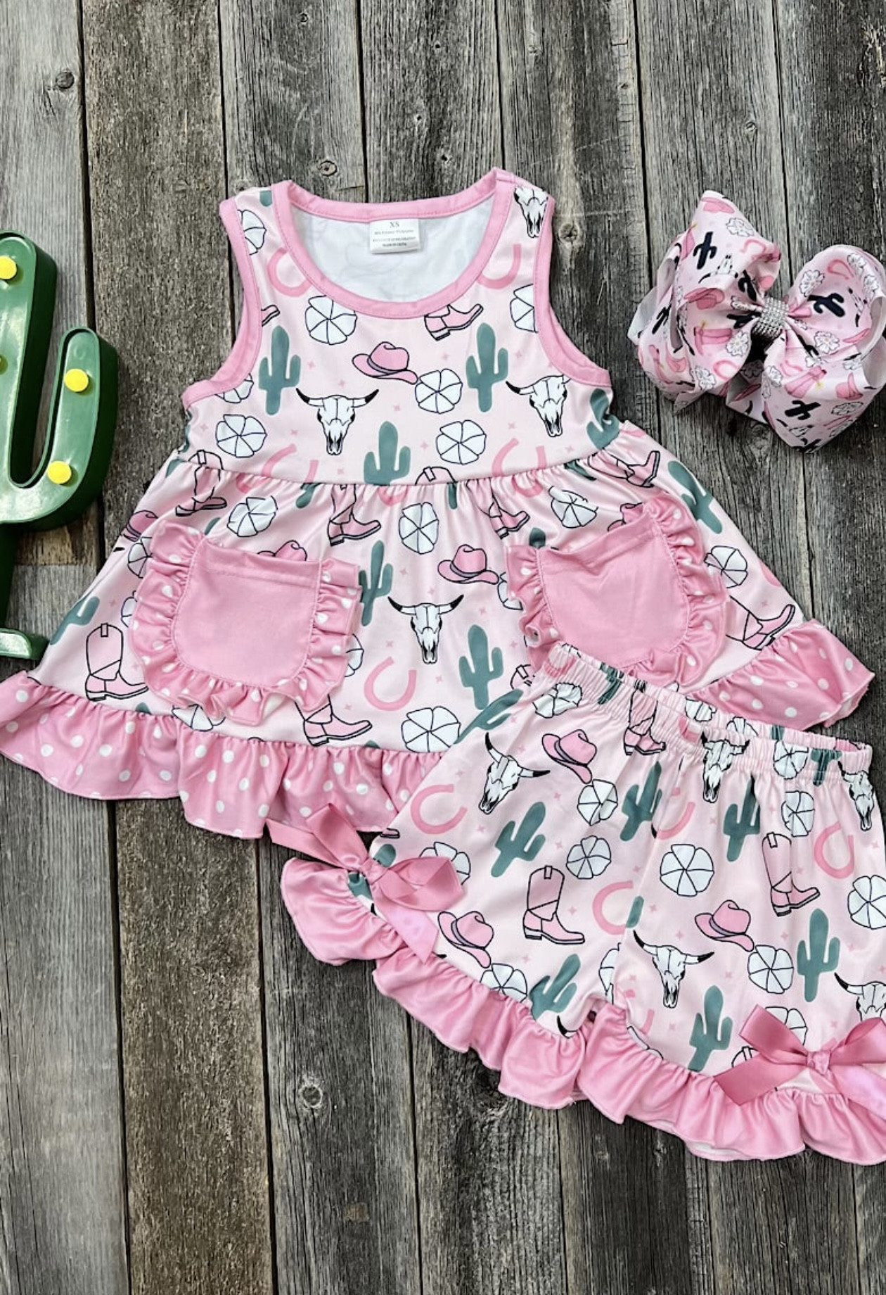 Light pink 2 pc shorts set with cactus, cowgirl hat and cow skull print